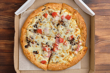 Pizza carbonara packaged for delivery with top view