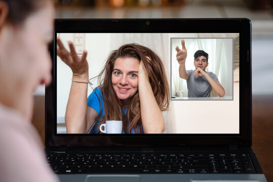 Woman having video conversation on laptop at home