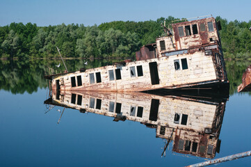 Abandoned sunken Barges Boats On River Pripyat in Chernobyl exclusion Zone. Chernobyl Nuclear Power...