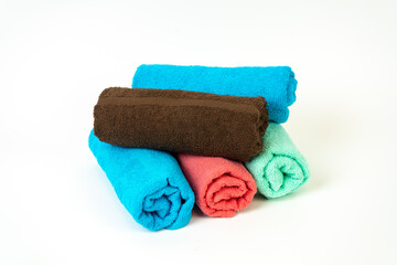Five towels rolled up in a roll of different colors.