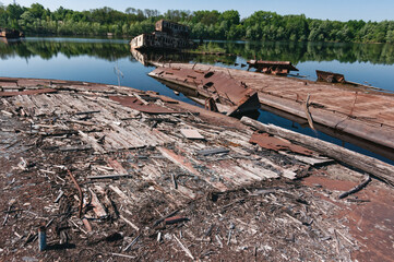 Abandoned sunken Barges Boats On River Pripyat in Chernobyl exclusion Zone. Chernobyl Nuclear Power Plant Zone of Alienation in Ukraine