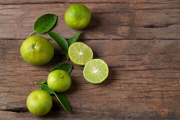 Half sliced lime fruits on wood plate