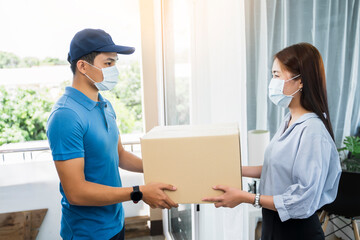 Deliveryman delivering package box parcel giving to female customer at home wearing face mask safety coronavirus covid-19 infection customer delivery service logistics ordering mail posting business