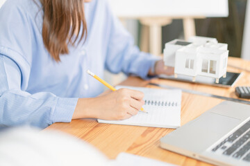 Asian architect man and woman working with laptop and blueprints,engineer inspection in workplace for architectural plan,sketching a construction project ,selective focus,Business concept