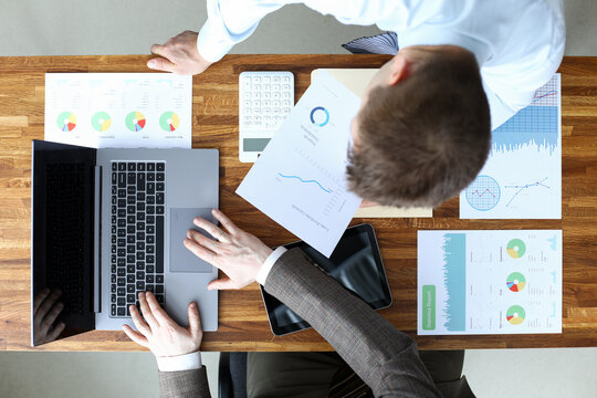 Men coordinate work on documents electronically