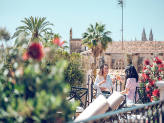 Women toasting with drinks in cafe