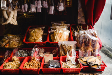 Chinese delicatessen in assortment for sale on local stall market in street of Hong Kong
