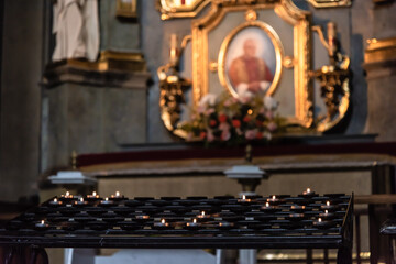 The interior of the catholic church. candles. portrait of the pope in the catholic cathedral. Ukraine, Lviv.