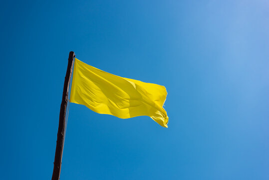 Yellow Flag On Blue Sky Background