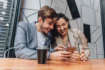 Couple using phone at a bar
