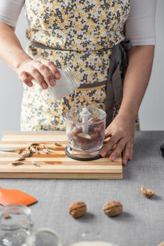 Woman pouring cream into a blender