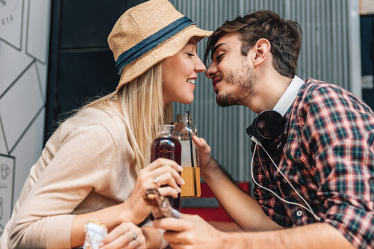 Couple kissing at a bar - Powered by Adobe