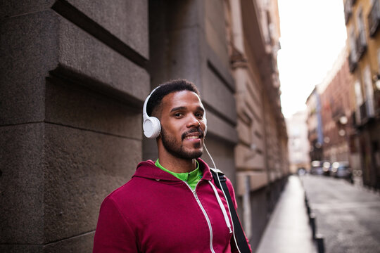 Young man listening music around the city