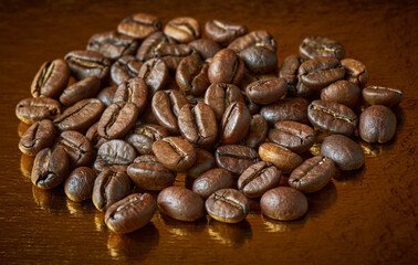 Fragrant coffee beans on a golden background, closeup, shallow depth of sharpness