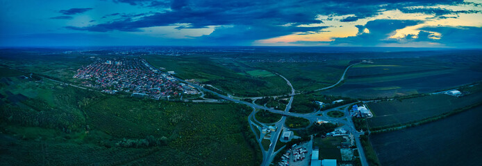 Aerial high drone flight over evening road traffic. Highway and overpass with cars and trucks, interchange, two-level road junctio. Freeway, line.