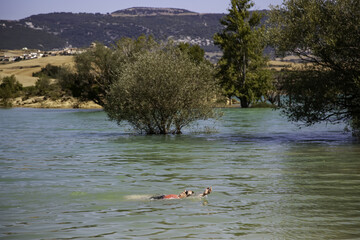 Person swimming in reservoir
