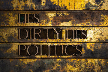 Lies Dirty Lies Politics text formed with real authentic typeset letters on vintage textured silver grunge copper and gold background