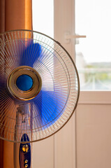 Working fan in the room near the window.