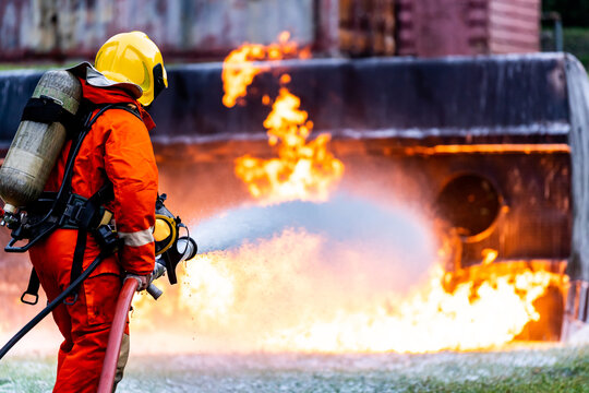 Firefighters spraying down fire flame from oil tanker truck accident