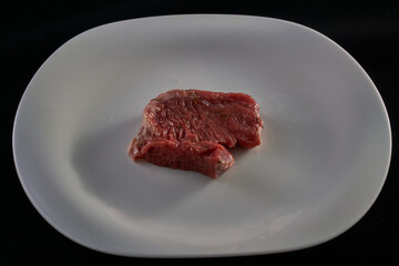 Fresh steak meat on a white plate