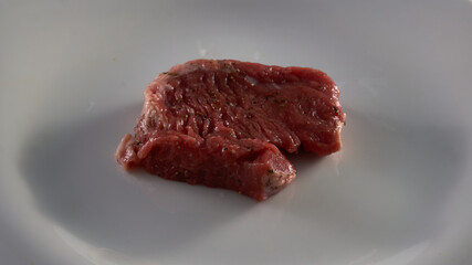 Fresh steak meat on a white plate