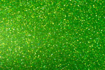 Glamor green sparkling background. Blured glitter background. Holiday abstract texture. Background of blue lights.
