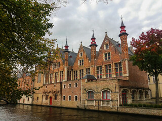 Fototapeta na wymiar Canal and old buildings in the medieval city of Bruges in northern Belgium. This city is known as Venice of the North by its canals in the center of the city.