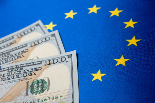 European Union flag and the dollar bills. Business and finance concept, soft focus - Powered by Adobe