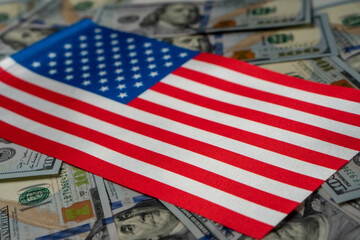 USA Flag with US dollars as background. Concept for investors, soft focus