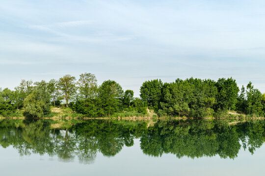 Reflection of green trees in water surface of lake called Zelena voda in Slovakia.