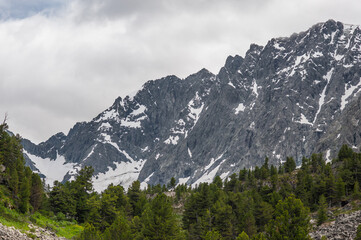 Fototapeta na wymiar snowy cliffs with overcast skies in the Altai Mountains
