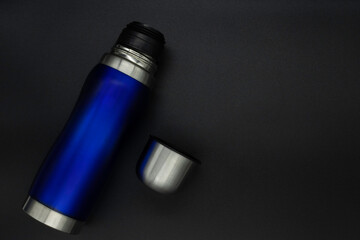 Thermos for hot drinks on black background