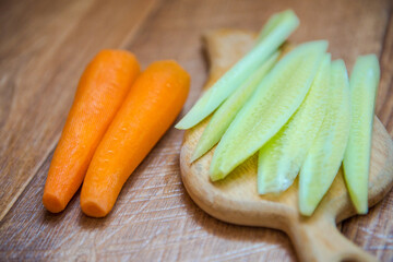cucumbers and carrots. Healthy food, healthy drink. healthy eating for breakfast. Wood background. Peeled vegetables on a cutting board