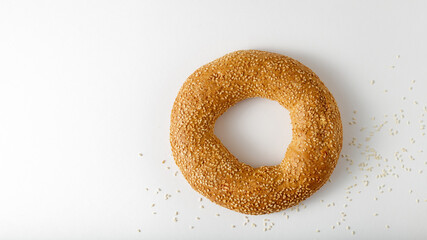 Traditional turkish simit bagel with sesame on light background with copy space