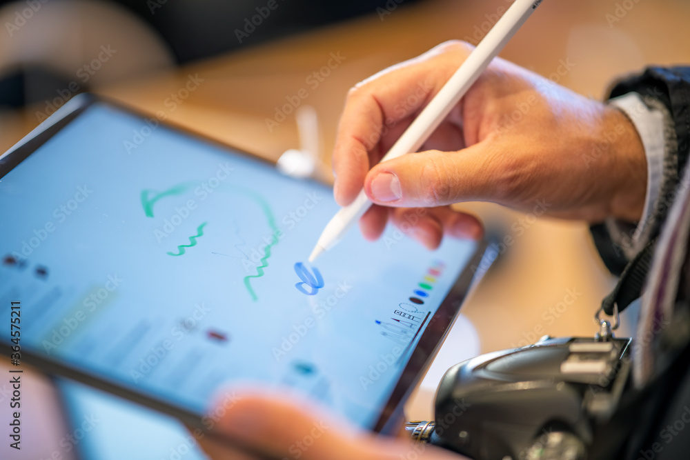 Poster man using tablet with a pen. detail on hands