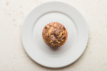Freshly Baked Banana Chocolate Walnut Muffin on White Plate- Solo Flat lay