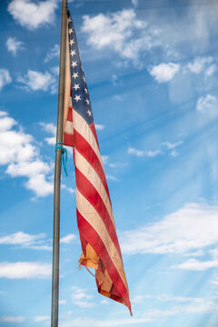 American flag against blue sky landscape, USA