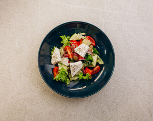 Greek salad on grey table. top view, flat lay