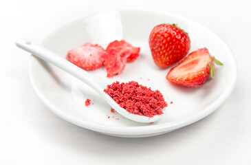 Strawberry powder made of freeze dried strawberries for sprinkle. Flavor and color ingredient for food. Top view, white minimal background, copy space. Great source of vitamin C and iron.