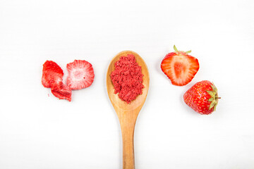 Strawberry powder made of freeze dried strawberries for sprinkle. Flavor and color ingredient for food. Top view, white minimal background, copy space. Great source of vitamin C and iron.