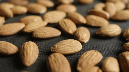 Macro shot of Almonds lays on black desk