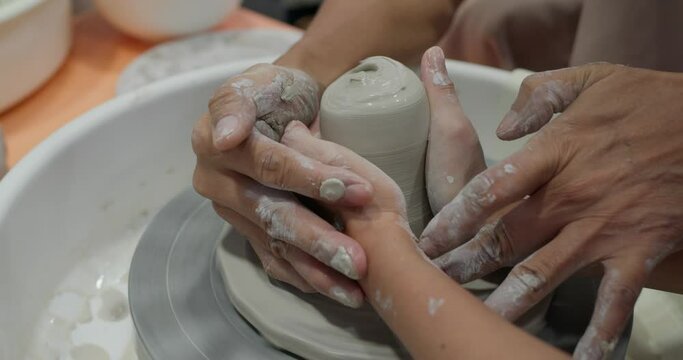 Hand work on pottery wheel, shaping a clay pot