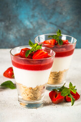 Cheesecake in the glasses with fresh strawberry.