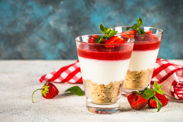 Cheesecake in the glasses with fresh strawberry.