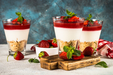 Cheesecake in the glasses with fresh strawberry.