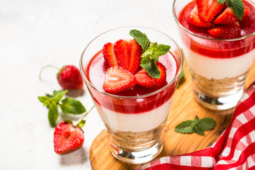 Cheesecake in the glasses with fresh strawberry.