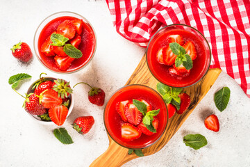 Cheesecake in the glasses with fresh strawberry.