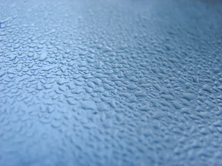 Blue metallic surface with droplets