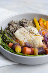 Healthy lunch or dinner bowl with vegetables and fish