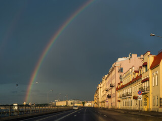 Morning rainbow over the embankment of St. Petersburg